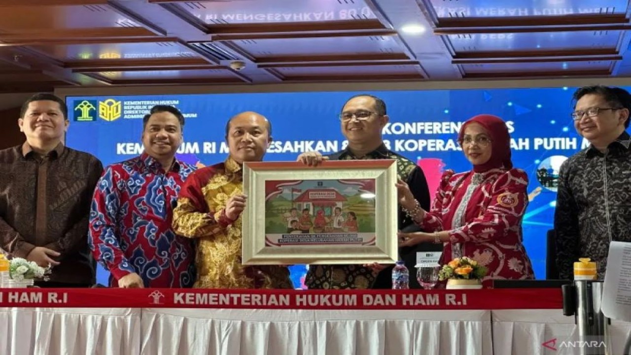 Direktur Jenderal Administrasi Hukum Umum Kementerian Hukum Widodo (ketiga kanan) saat berfoto bersama sebagai simbolisasi penyerahan SK 80.068 Koperasi Merah Putih, di Gedung Kemenkum, Jakarta, Jumat (18/7/2025). ANTARA/Rio Feisal.